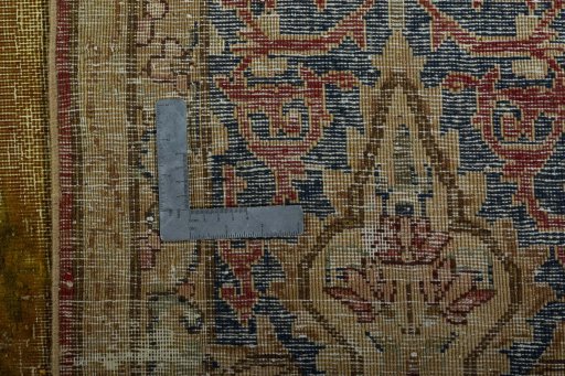 Backside of handmade 1950s Vintage rug showing knot structure and weave density