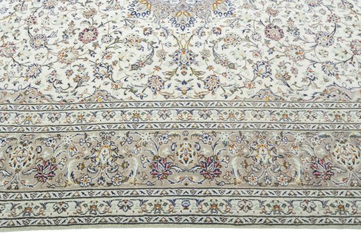 Corner detail of 2000s Kashan rug showing border pattern and Wool pile