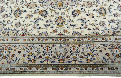 Corner detail of 2000s Kashan rug showing border pattern and Wool pile