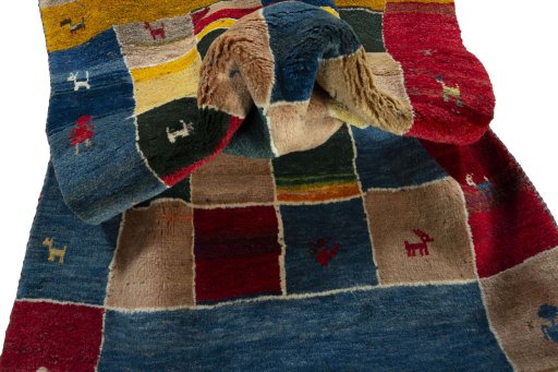 Corner detail of 2000s Persian Gabbeh rug showing border pattern and Wool pile