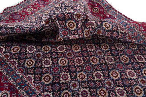 Corner detail of 2000s Mashad rug showing border pattern and Wool pile