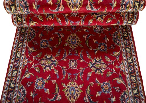 Corner detail of 2000s Kashan rug showing border pattern and Wool pile
