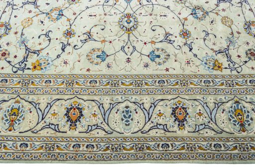 Corner detail of 2000s Kashan rug showing border pattern and Wool pile