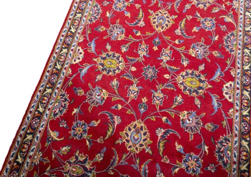 Backside of handmade 2000s Kashan rug showing knot structure and weave density