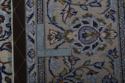 Backside of handmade 2000s Kashan rug showing knot structure and weave density