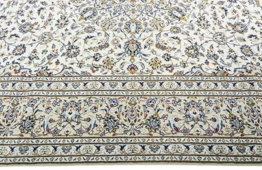 Corner detail of 2000s Kashan rug showing border pattern and Wool pile
