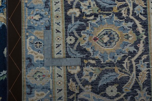 Backside of handmade 2000s Kashan rug showing knot structure and weave density