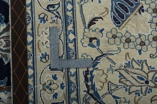 Backside of handmade 2000s Nain rug showing knot structure and weave density