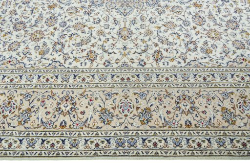 Corner detail of 2000s Kashan rug showing border pattern and Wool pile