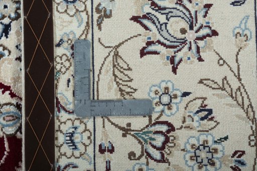 Backside of handmade New Nain rug showing knot structure and weave density
