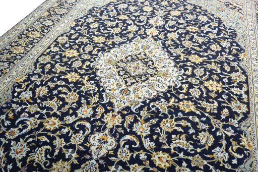 Backside of handmade 2000s Kashan rug showing knot structure and weave density