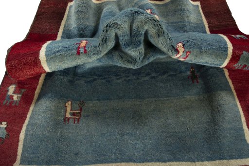 Corner detail of 2000s Persian Gabbeh rug showing border pattern and Wool pile