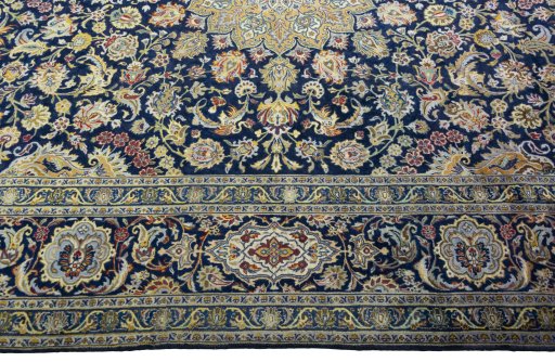 Corner detail of 2000s Kashan rug showing border pattern and Wool pile