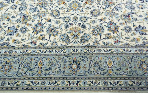 Corner detail of 2000s Kashan rug showing border pattern and Wool pile