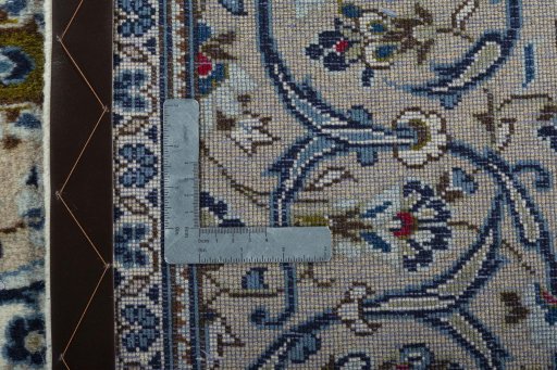 Backside of handmade 2000s Kashan rug showing knot structure and weave density