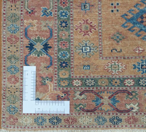 Corner detail of New Kazak rug showing border pattern and Wool pile