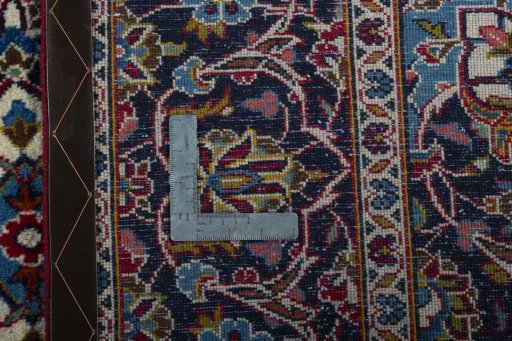 Backside of handmade 2000s Kashan rug showing knot structure and weave density