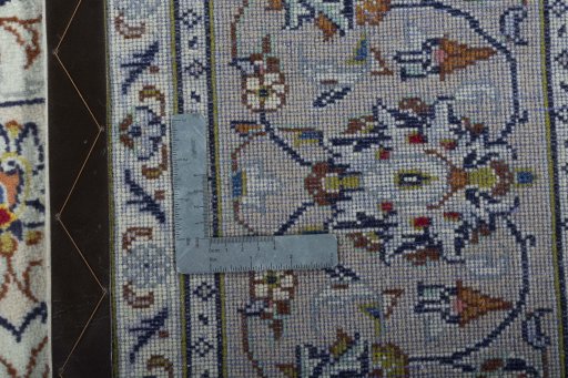 Backside of handmade 2000s Kashan rug showing knot structure and weave density