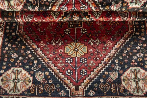 Corner detail of 2000s Shiraz rug showing border pattern and Wool pile