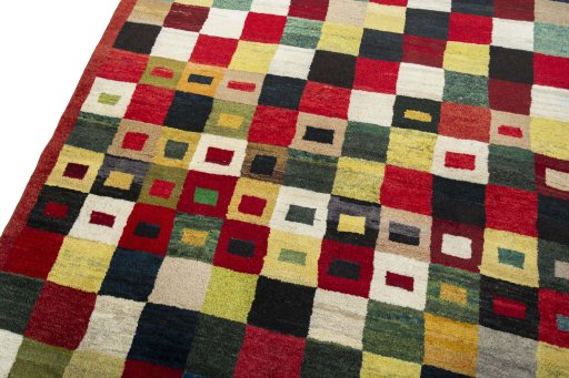 Backside of handmade 2000s Persian Gabbeh rug showing knot structure and weave density
