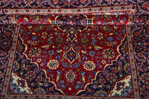 Corner detail of 2000s Kashan rug showing border pattern and Wool pile