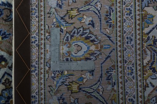 Backside of handmade 2000s Kashan rug showing knot structure and weave density