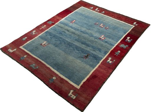 Corner detail of 2000s Persian Gabbeh rug showing border pattern and Wool pile