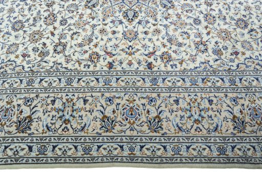 Corner detail of 2000s Kashan rug showing border pattern and Wool pile
