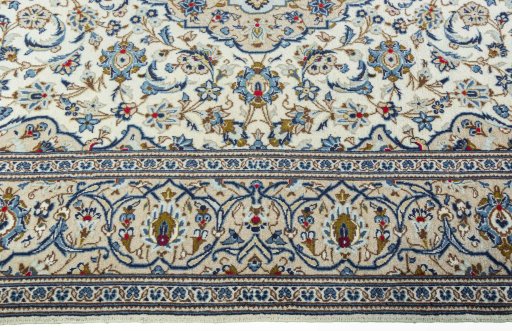 Corner detail of 2000s Kashan rug showing border pattern and Wool pile
