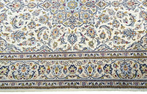 Corner detail of 2000s Kashan rug showing border pattern and Wool pile