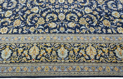 Corner detail of 2000s Kashan rug showing border pattern and Wool pile