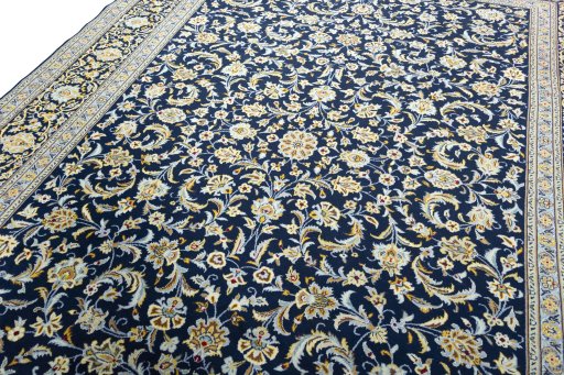 Backside of handmade 2000s Kashan rug showing knot structure and weave density