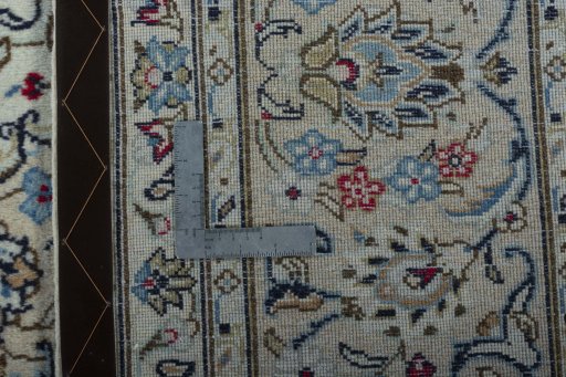 Backside of handmade 2000s Kashan rug showing knot structure and weave density