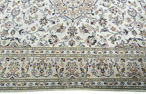 Corner detail of 2000s Kashan rug showing border pattern and Wool pile