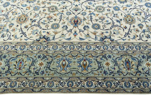 Corner detail of 2000s Kashan rug showing border pattern and Wool pile