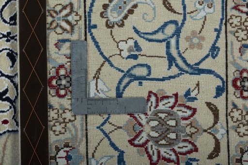 Backside of handmade 2000s Nain rug showing knot structure and weave density