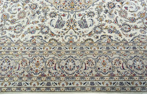 Corner detail of 2000s Kashan rug showing border pattern and Wool pile