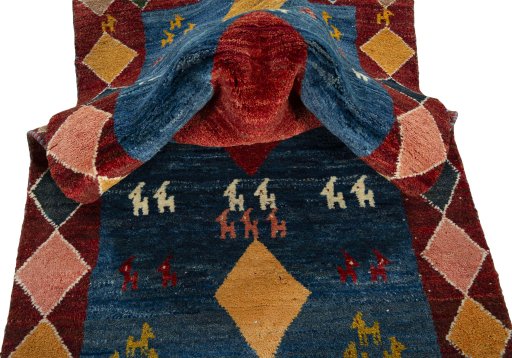 Corner detail of 2000s Persian Gabbeh rug showing border pattern and Wool pile