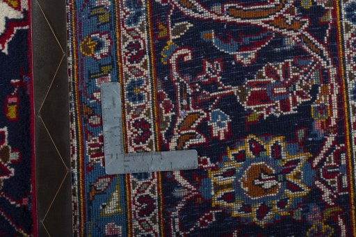 Backside of handmade 2000s Kashan rug showing knot structure and weave density