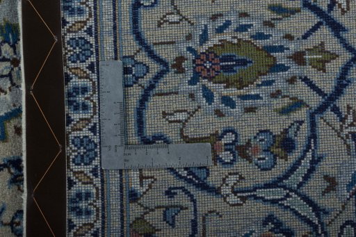 Backside of handmade 2000s Kashan rug showing knot structure and weave density