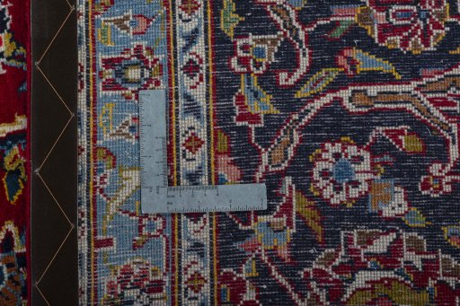 Backside of handmade 2000s Kashan rug showing knot structure and weave density