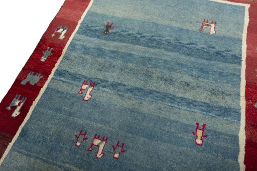 Backside of handmade 2000s Persian Gabbeh rug showing knot structure and weave density
