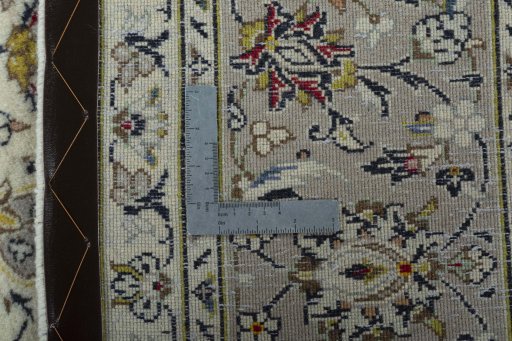 Backside of handmade New Kashan rug showing knot structure and weave density