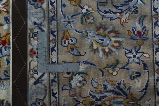 Backside of handmade 2000s Kashan rug showing knot structure and weave density