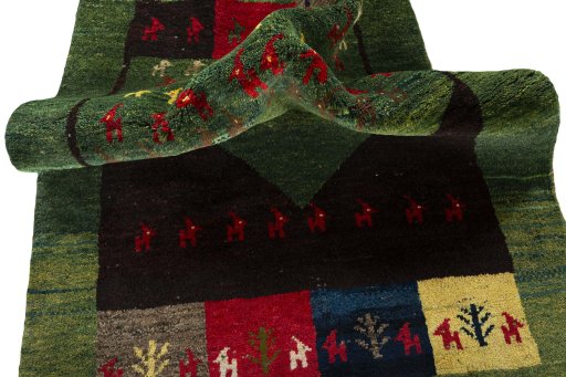 Corner detail of 2000s Persian Gabbeh rug showing border pattern and Wool pile