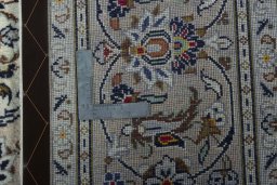 Backside of handmade 2000s Kashan rug showing knot structure and weave density
