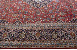 Corner detail of New Kashan rug showing border pattern and Cork pile
