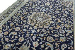 Backside of handmade 2000s Kashan rug showing knot structure and weave density