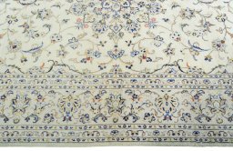 Corner detail of 2000s Kashan rug showing border pattern and Wool pile