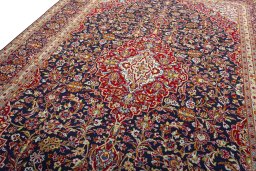Backside of handmade 2000s Kashan rug showing knot structure and weave density